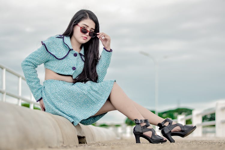 Stylish Girl Sitting On A Gutter