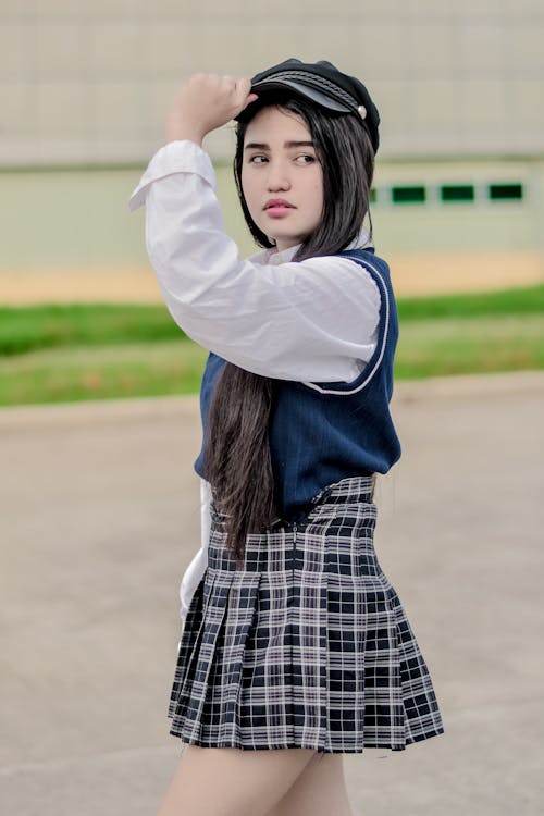 A Woman Wearing Cap and Skirt