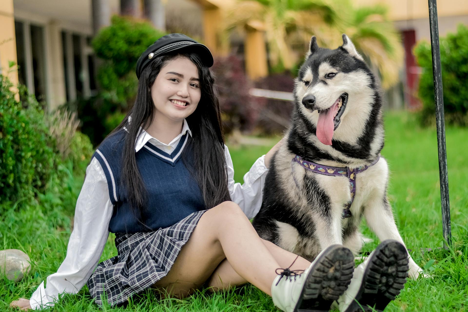 Woman Sitting with Husky Dog