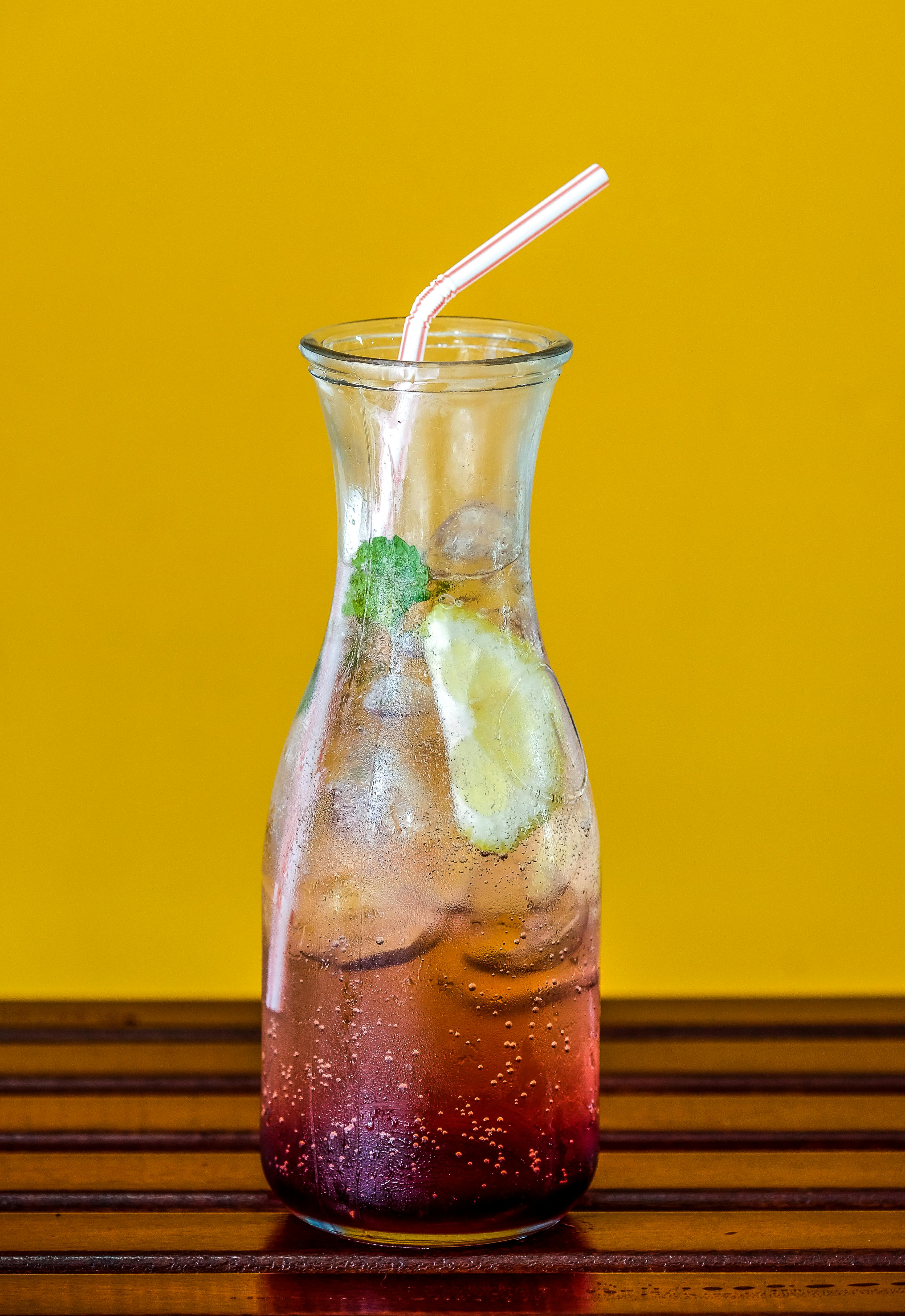 clear glass pitcher filled with juice