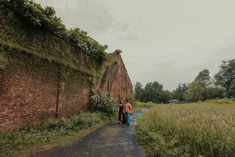 A Couple Walking On A Footpath