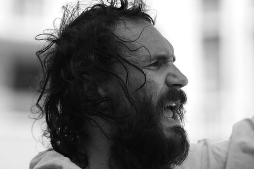 Free Close-up black and white portrait of a bearded man expressing strong emotions outdoors in Brussels. Stock Photo