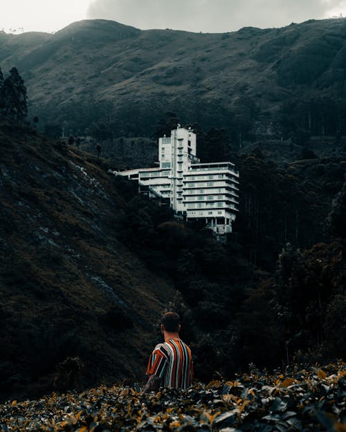 A Person Looking at a Building on the Mountain