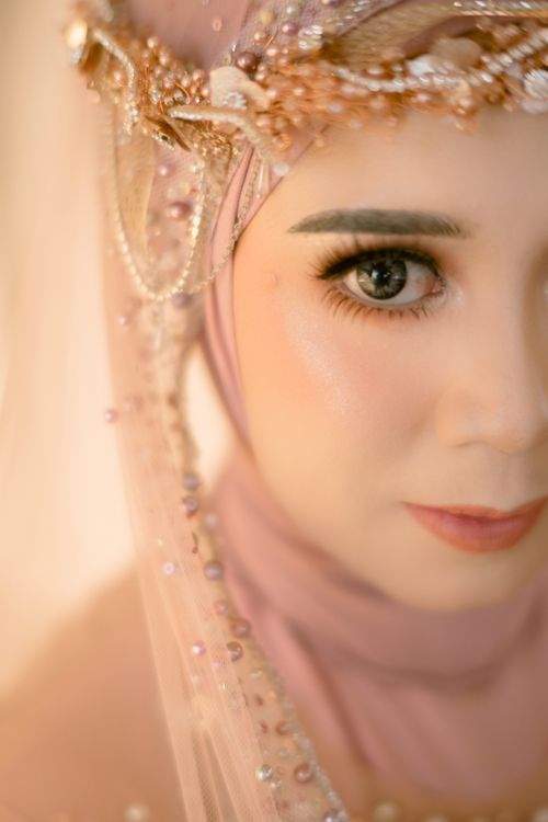 Free A close-up portrait of a woman wearing elegant traditional clothing with detailed beadwork. Stock Photo