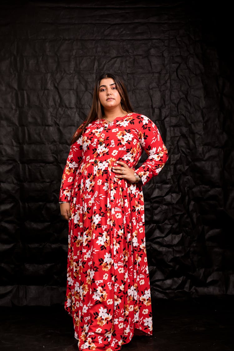 A Woman In Red And White Floral Dress Standing 