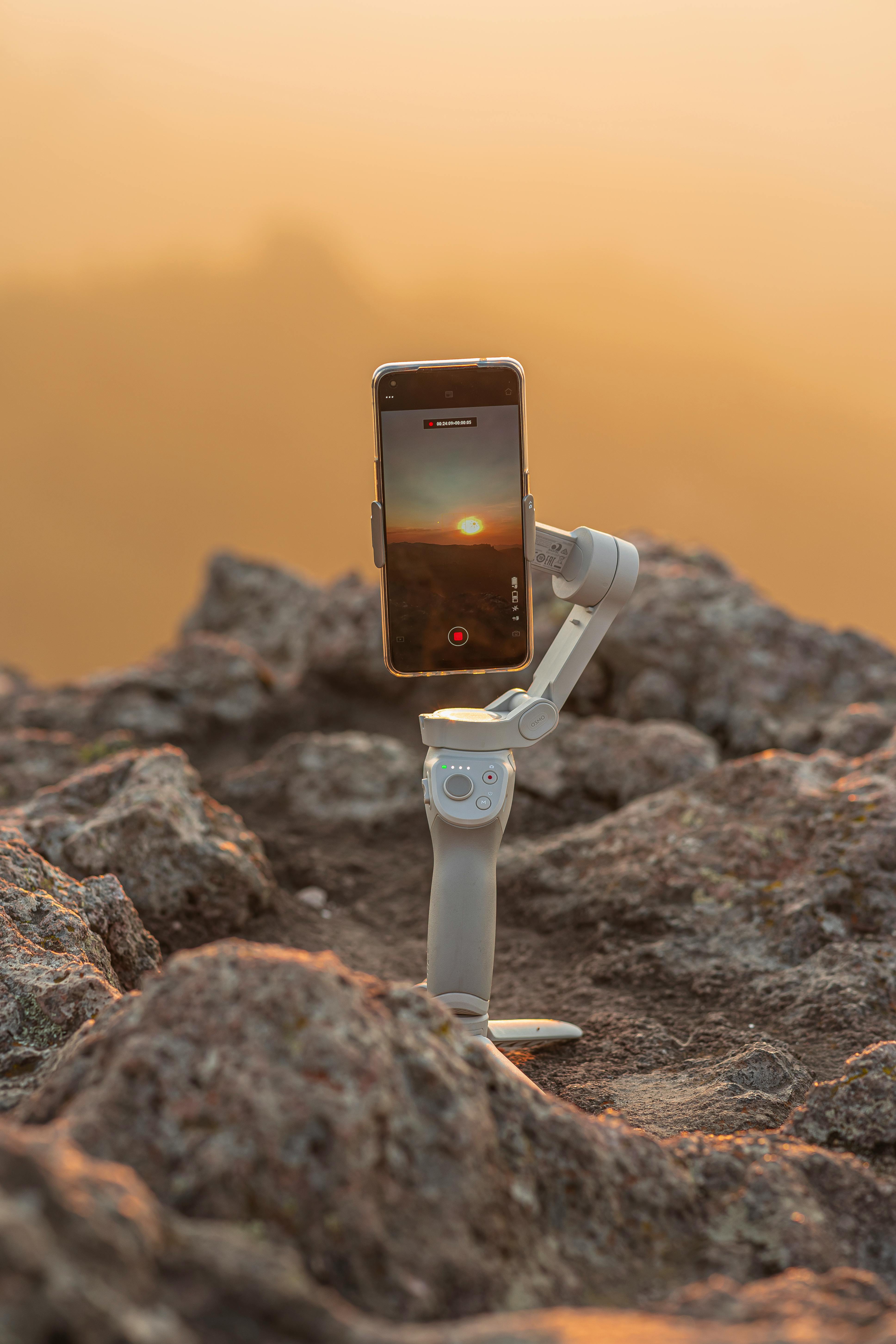 smartphone on tripod on rock filming sunset