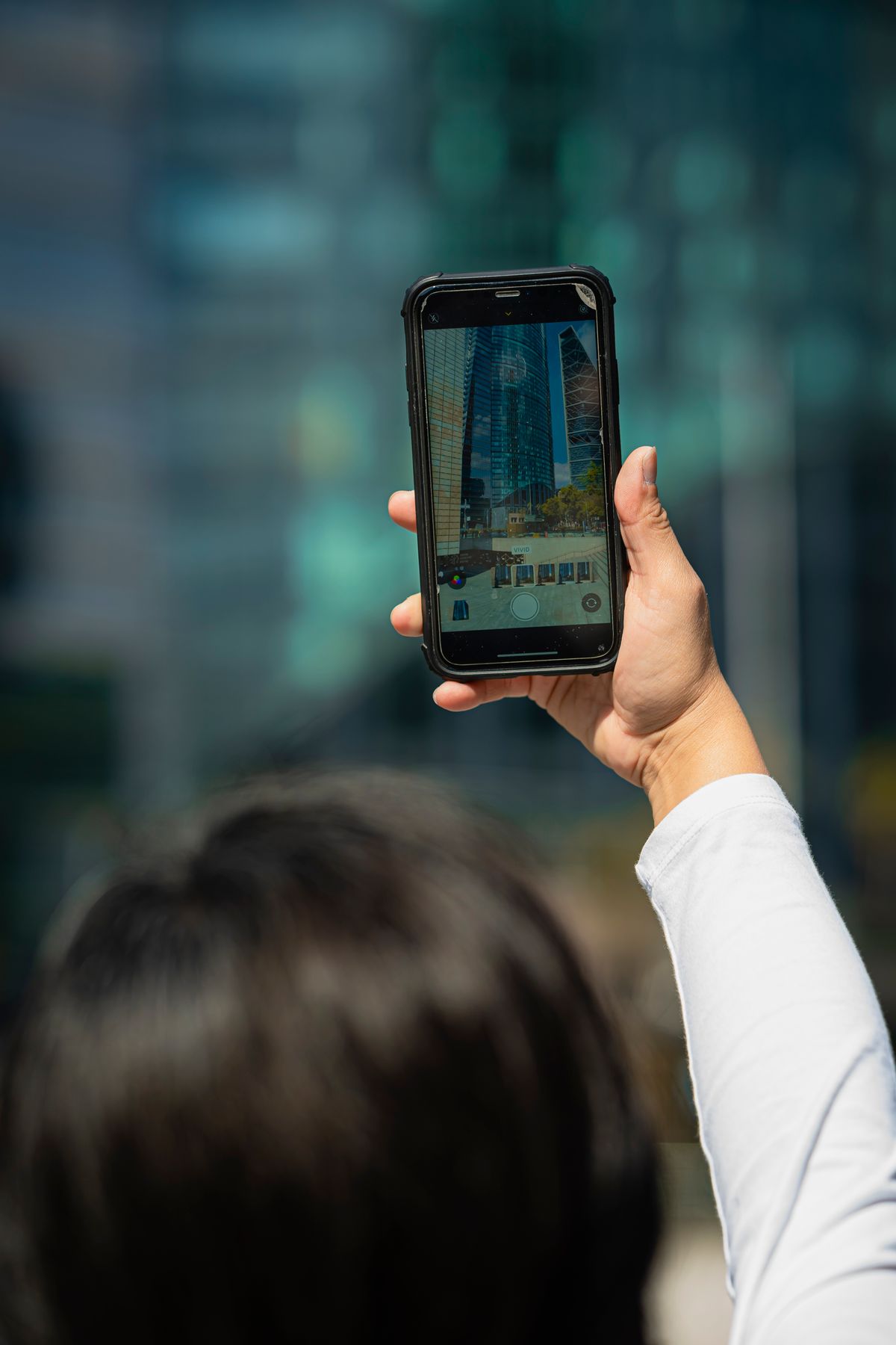 Person taking a steady smartphone photo of a building