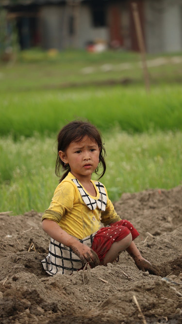 Girl Sitting And Playing With Sand