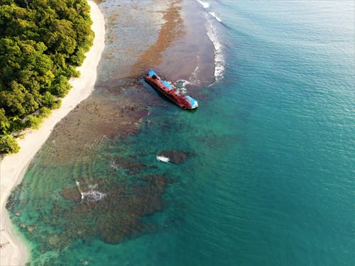 An Aerial Shot of a Shore with a Wrecked Ship