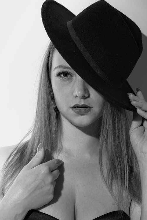 A Grayscale of a Woman Wearing a Hat