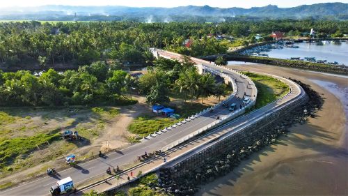 Free Stunning aerial shot of a coastal road and lush landscape in Pangandaran, Indonesia. Stock Photo