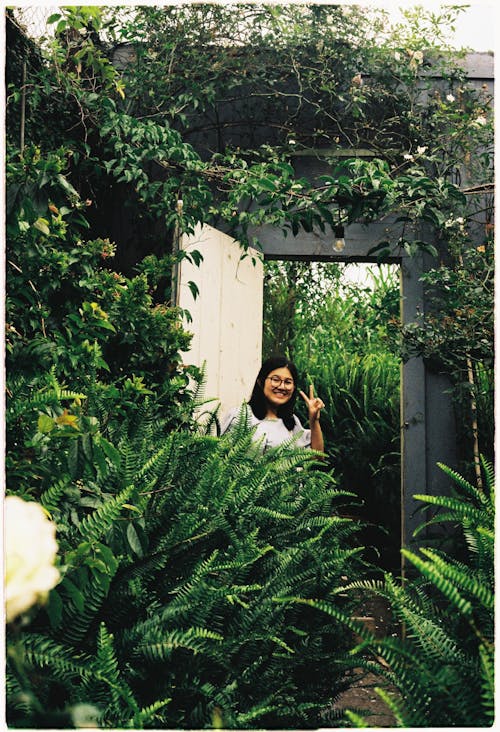 Woman in White Blouse Standing on a Doorway