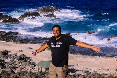 Photography of Man in Black Shirt Near Body of Water