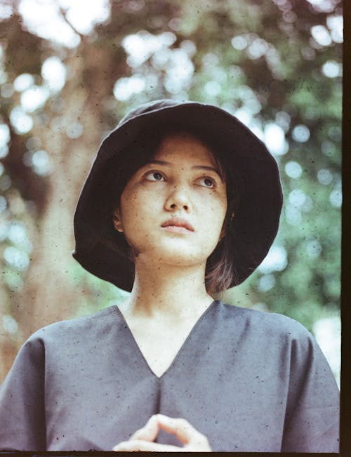 Close-Up Shot of a Woman Wearing Black Hat