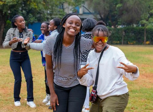 Free A joyful group of teenagers having fun outdoors at a playground, smiling and posing for the camera. Stock Photo