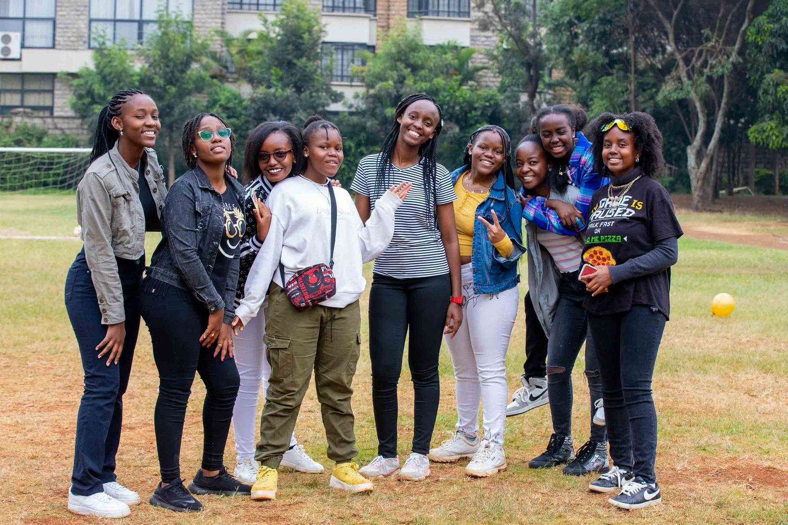 Smiling members of a partner organization celebrating together outdoors