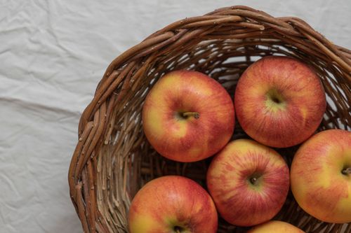 Free Close-up of ripe red apples in a rustic woven basket, ideal for harvest themes. Stock Photo