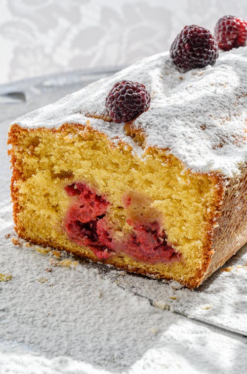 Close-Up Shot of a Delicious Fruit Cake with Raspberries on Top