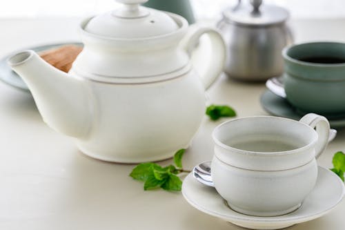 A Teapot beside a Cup and Saucer