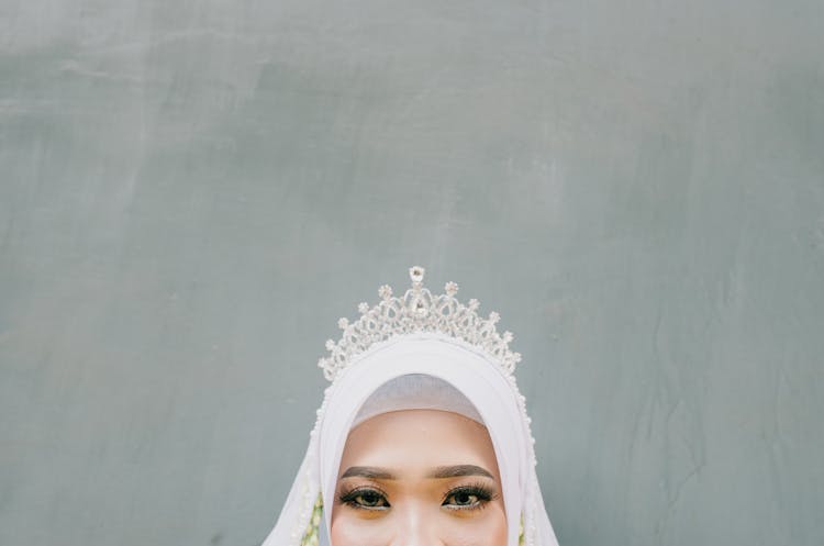 A Woman Wearing An Expensive Silver Crown While Looking At The Camera