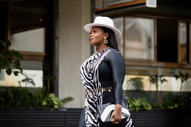 Stylish Woman In Hat Walking On City Street