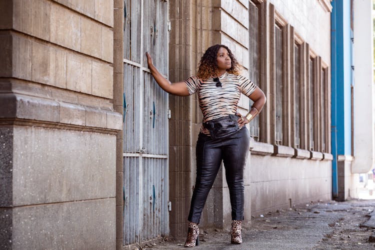 Woman Posing By Building Wall