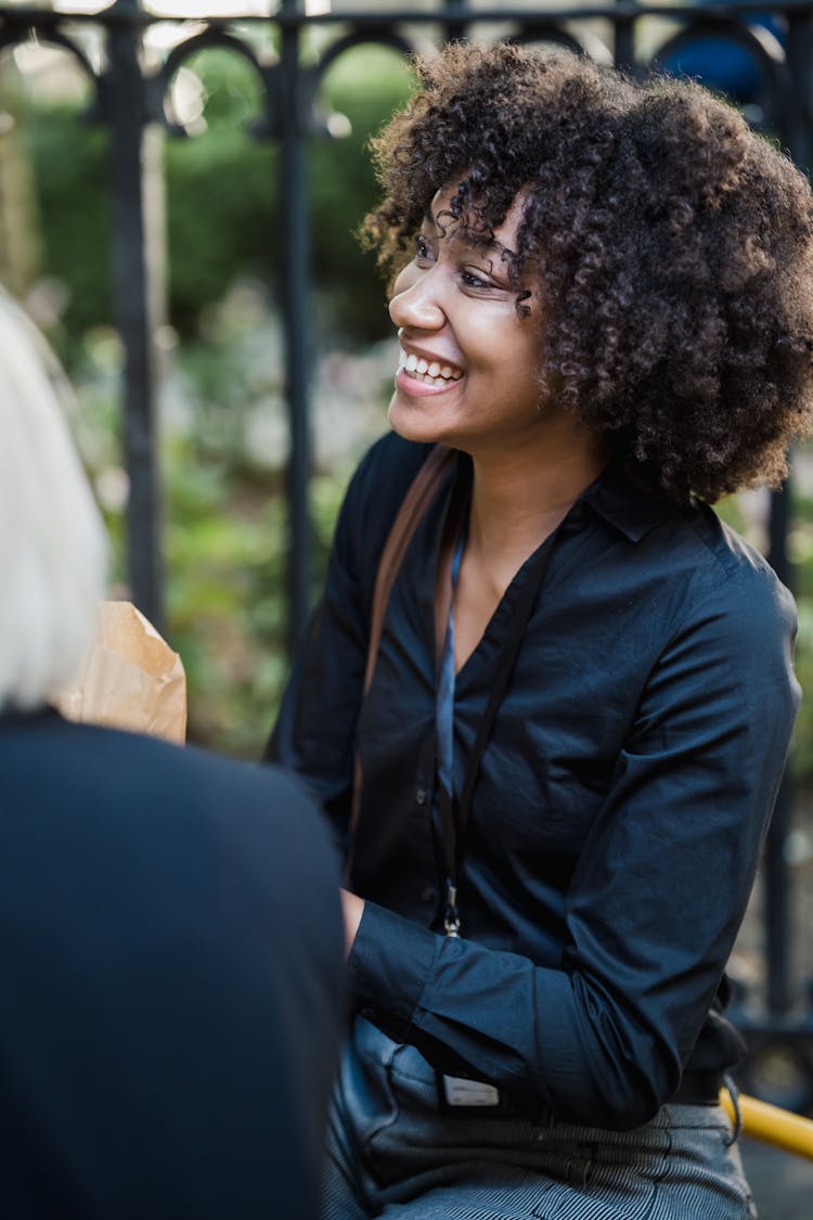 Woman In A Navy Shirt Smiling 