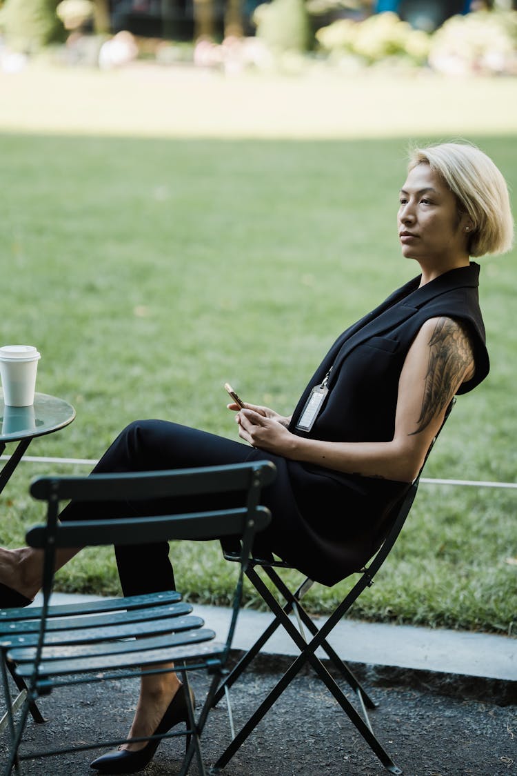 Woman Sitting In Garden Chair