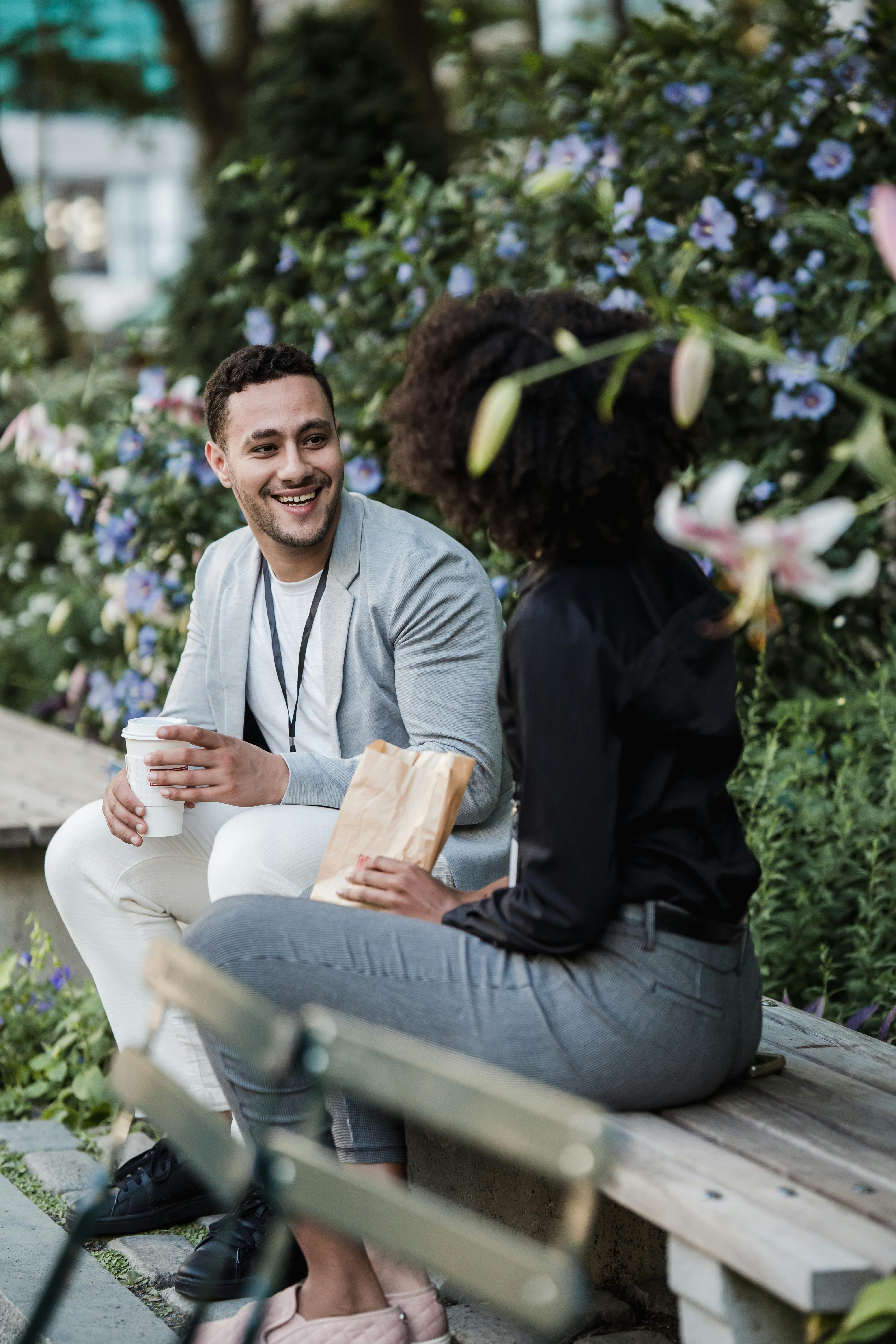 man and woman sitting on a bench on a lunch break