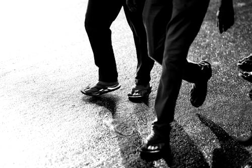 Legs of People Walking in Black and White