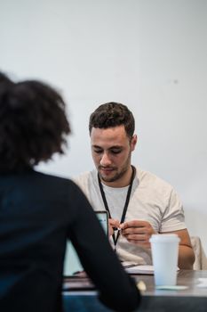 Two colleagues interacting in a modern office setting with a focus on collaboration.