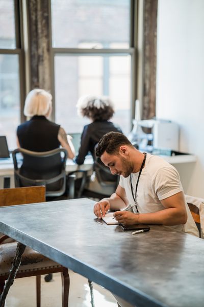 An open-plan office with people at work. Photo by Mizuno K on Pexels