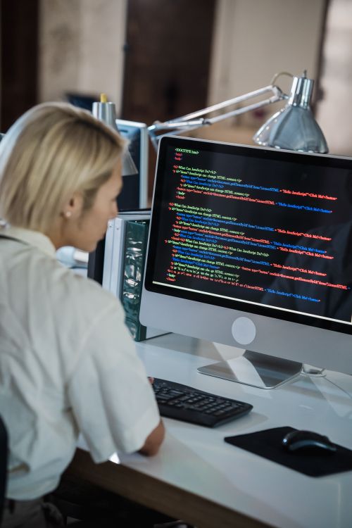 Blonde Computer Program Woman with Blond Hair Looking at Computer Screen with Multicoloured ...