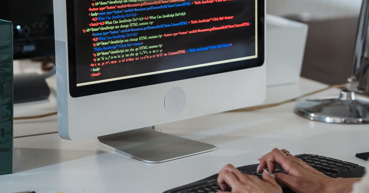 Write On Computer Screen Vertical Shot of Woman Writing on Computer in an Office and Colour Code ...