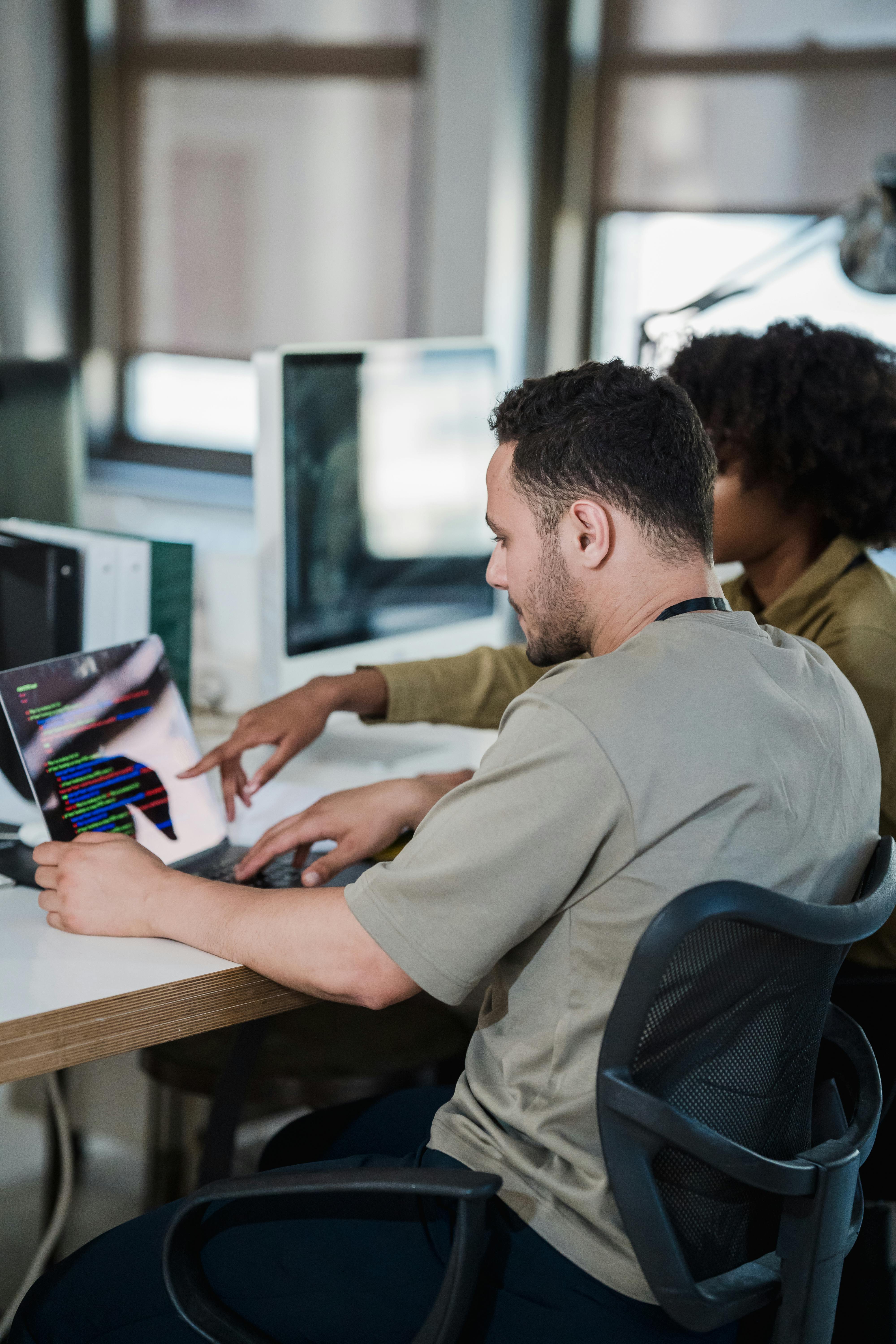 vertical shot of a man and woman working in an office