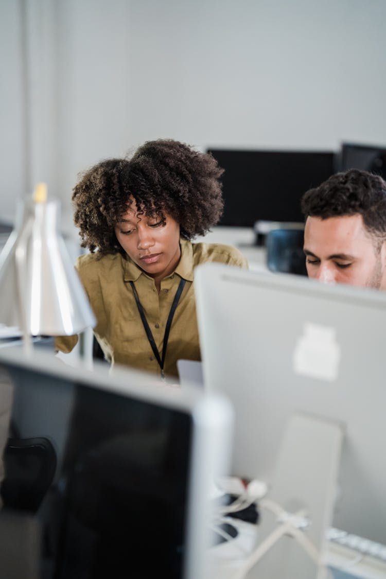 Man And Woman In An Office And Computer Screens