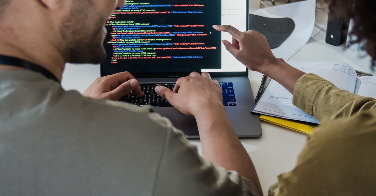 Man and Woman Talking about Programming · Free Stock Photo