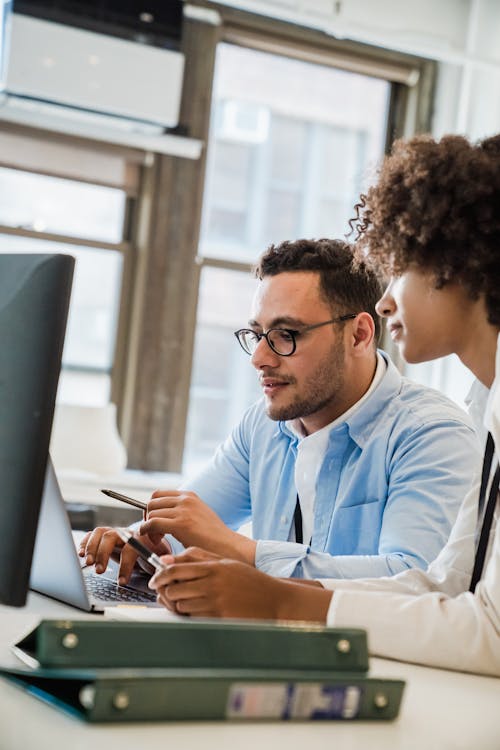 Man and Woman Sitting at Desk