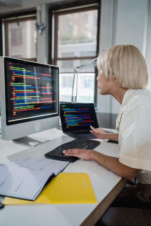 Blonde Computer Network Program Vertical Shot of a Blonde Woman Looking at Screen with Multicoloured ...
