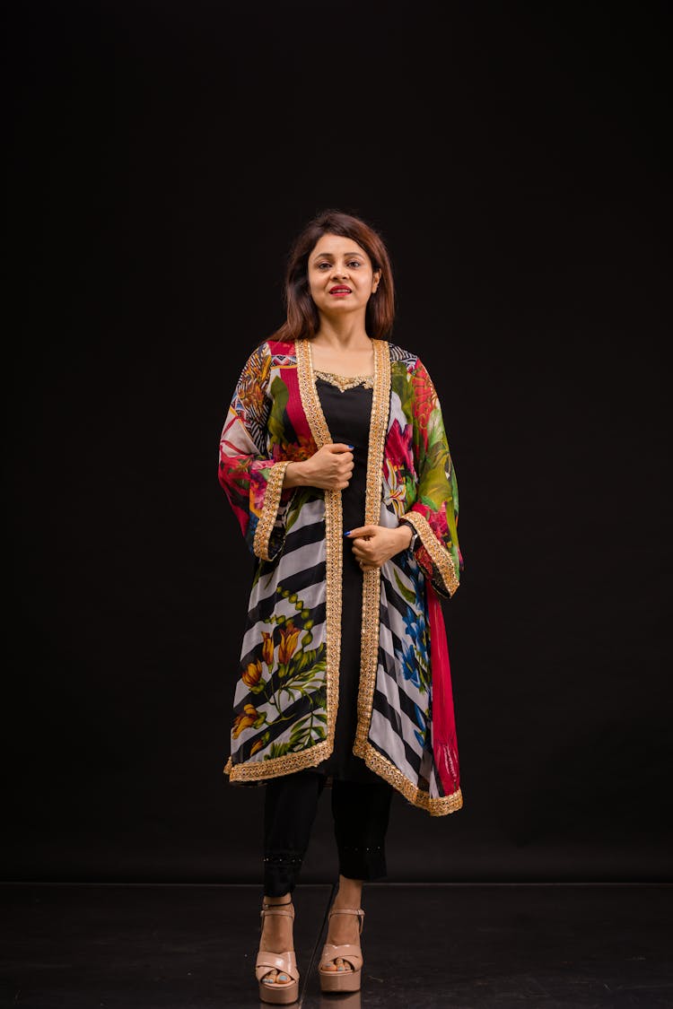 Woman In Traditional Costume In Black Studio