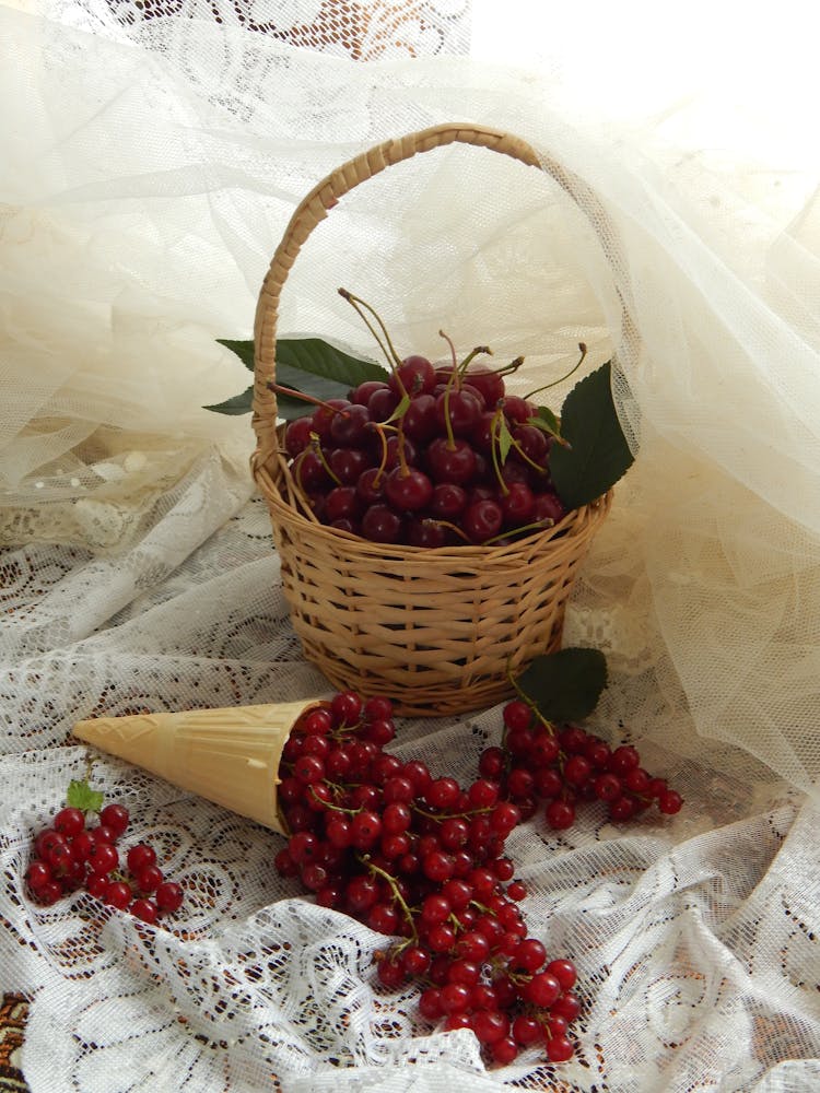 Basket Of Red Cherry On A White Lace Fabric