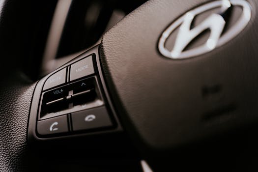 Detailed view of a car steering wheel with audio control buttons, focused on functionality.