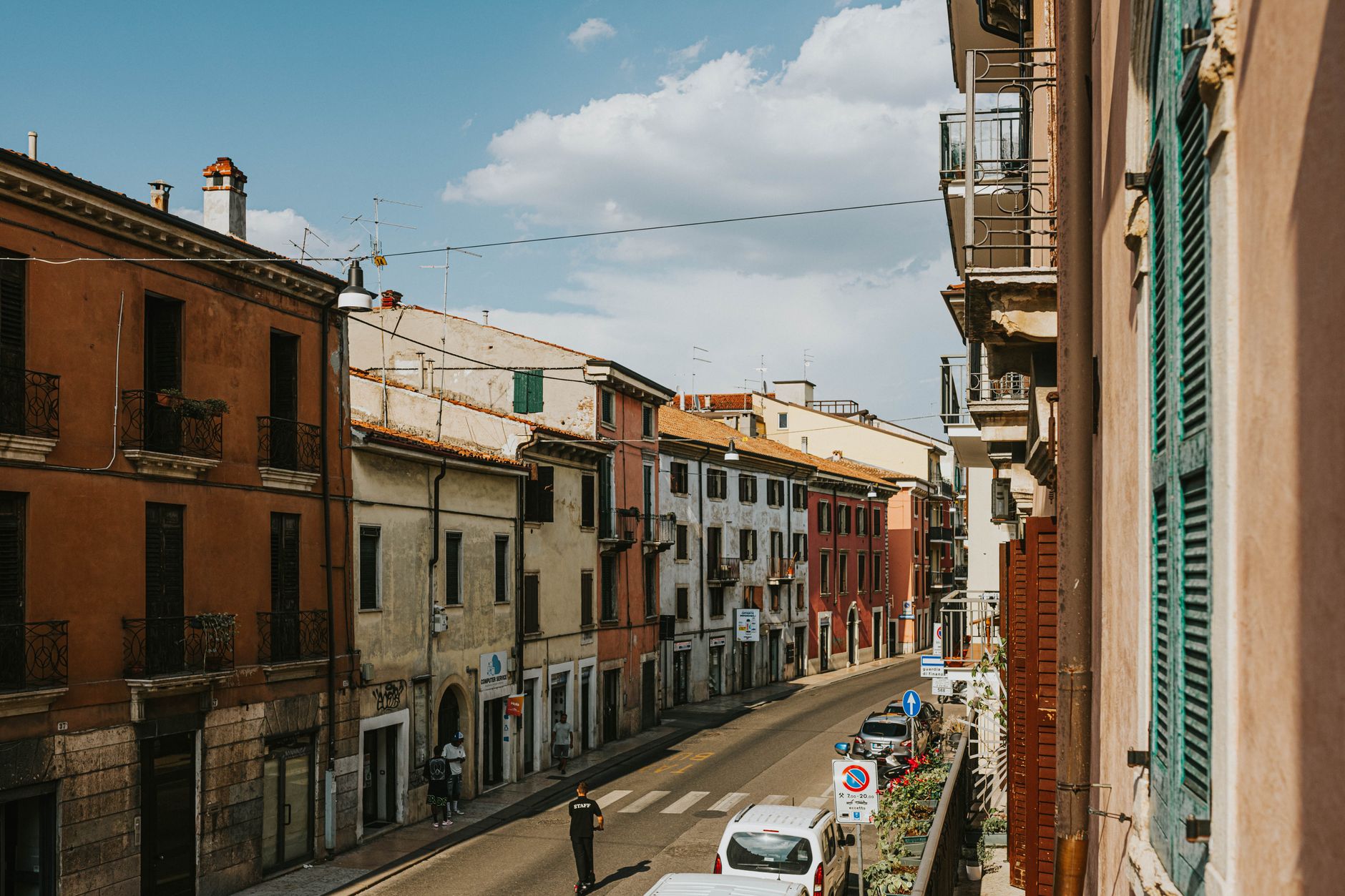Picturesque view of a weathered street in Verona, Italy with classic architecture and blue sky.
