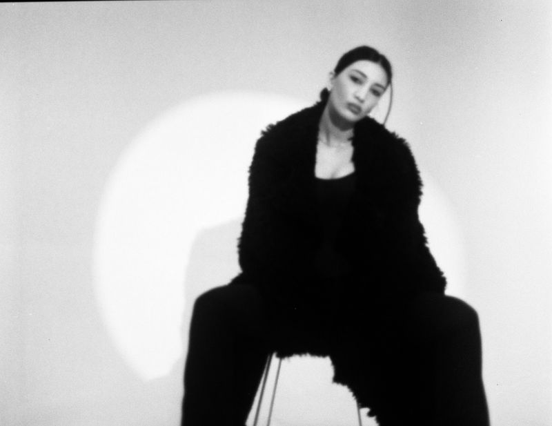 Black and white portrait of woman in black fur coat