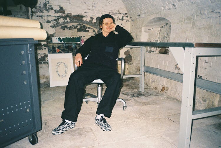 Man In Black Shirt Sitting In Basement