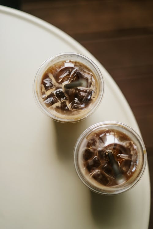 High Angle Shot of Drinks on Plastic Cups 