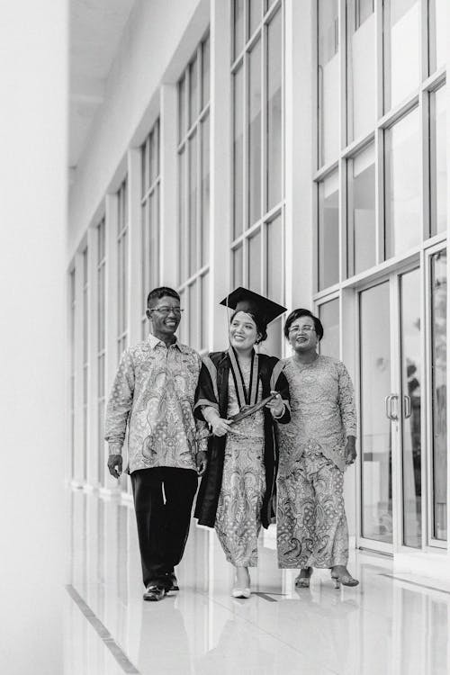 Smiling Women and Man Walking in Black and White
