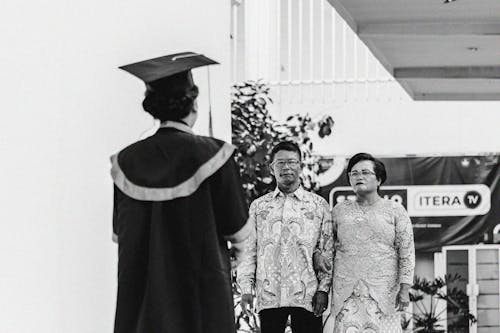 Black and White Photo of a Graduate with Parents 