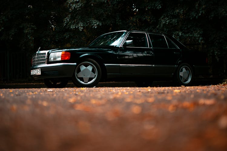 Black Car Parked On Concrete Pavement