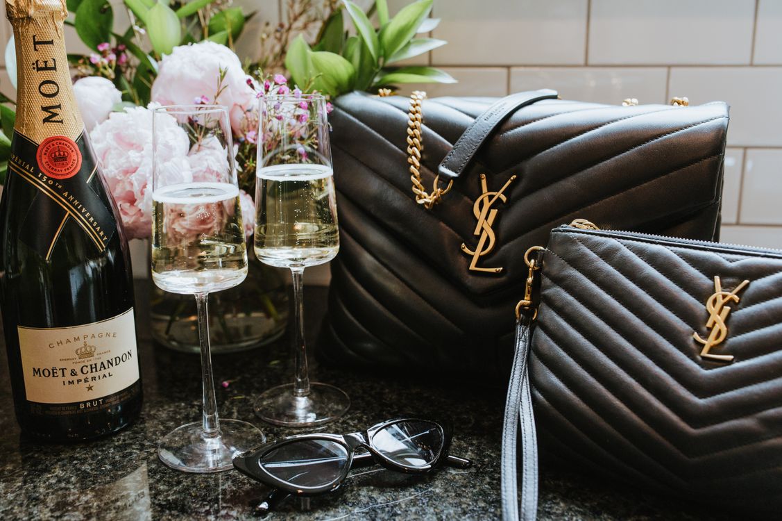 Free Champagne and Handbags Still Life Stock Photo